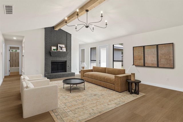 4524 Boston Dr, Plano, TX 75093 - living room with visible vents, wood finished floors, a fireplace, lofted ceiling with beams, and a notable chandelier