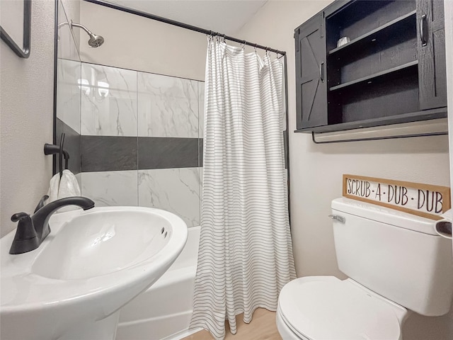 full bath featuring shower / tub combo, a sink, and toilet