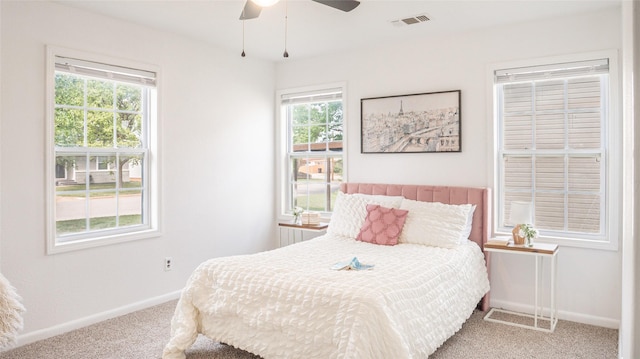 carpeted bedroom featuring ceiling fan, baseboards, and visible vents