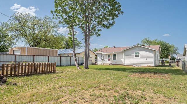 view of yard with a fenced backyard and a garage