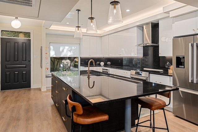 7404 W NW Hwy Unit 9, Dallas, TX 75225 - kitchen with wall chimney range hood, oven, white cabinetry, and stainless steel fridge with ice dispenser
