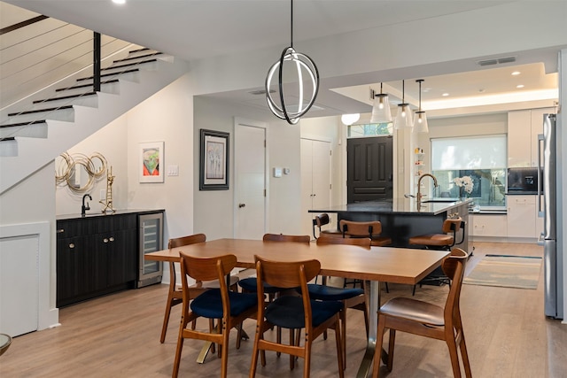 7404 W NW Hwy Unit 9, Dallas, TX 75225 - dining room featuring light wood-style floors, recessed lighting, wine cooler, and visible vents