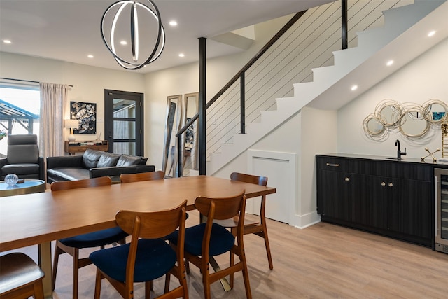 7404 W NW Hwy Unit 9, Dallas, TX 75225 - dining room with recessed lighting, wet bar, stairway, and light wood-style floors