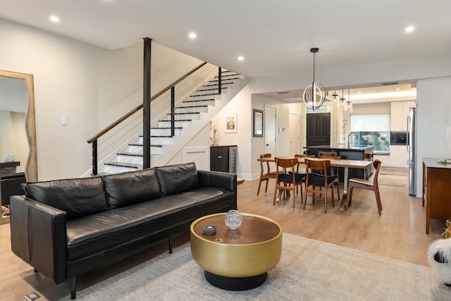 7404 W NW Hwy Unit 9, Dallas, TX 75225 - living room with recessed lighting, baseboards, light wood finished floors, and stairs