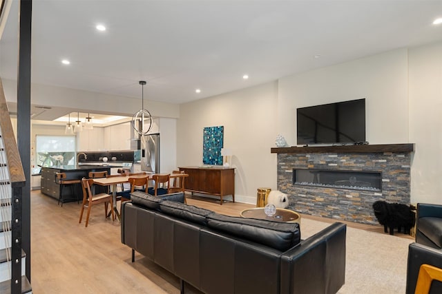 7404 W NW Hwy Unit 9, Dallas, TX 75225 - living room with light wood-style floors, recessed lighting, and a stone fireplace
