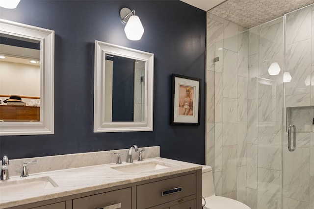 7404 W NW Hwy Unit 9, Dallas, TX 75225 - bathroom with double vanity, toilet, a shower stall, and a sink