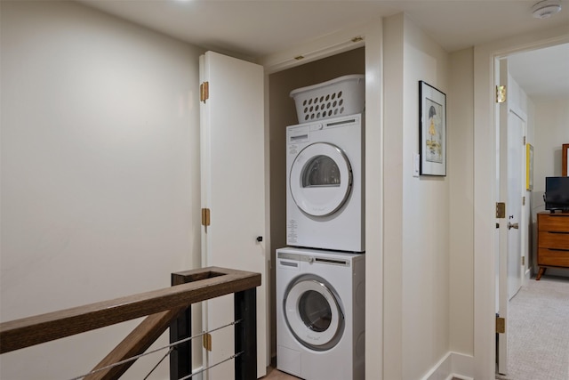 7404 W NW Hwy Unit 9, Dallas, TX 75225 - washroom with laundry area, stacked washer and clothes dryer, and baseboards