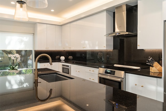 7404 W NW Hwy Unit 9, Dallas, TX 75225 - kitchen featuring a sink, wall chimney exhaust hood, backsplash, and white cabinets