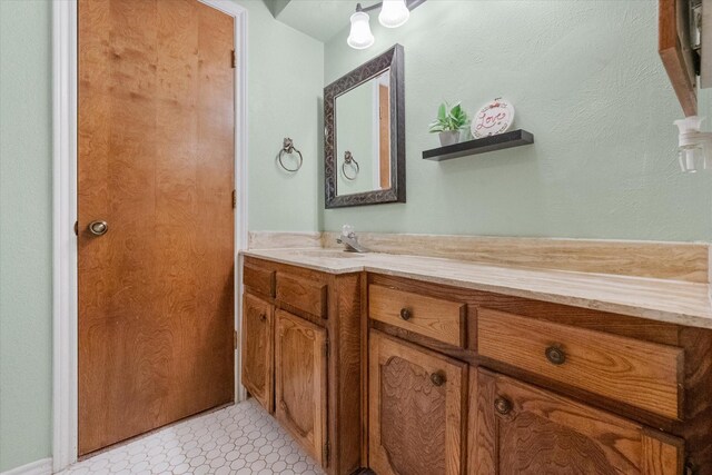 bathroom with tile patterned floors and vanity