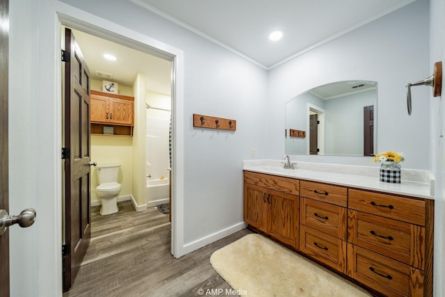 3734 Fm 600 S, Anson, TX 79501 - full bathroom with wood finished floors, vanity, baseboards, toilet, and ornamental molding