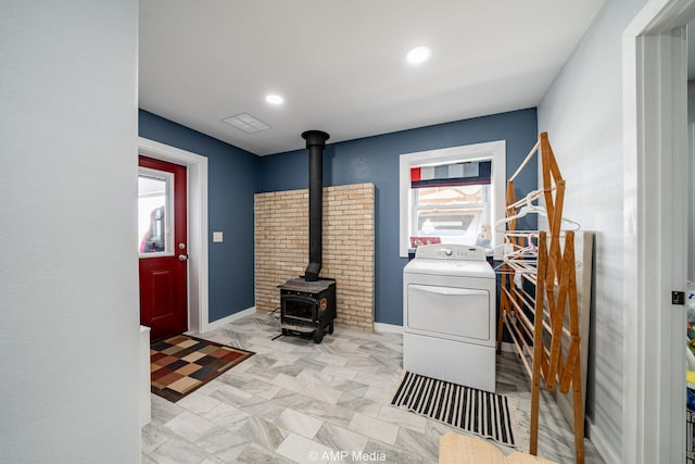 3734 Fm 600 S, Anson, TX 79501 - washroom featuring baseboards, recessed lighting, washer / clothes dryer, laundry area, and a wood stove
