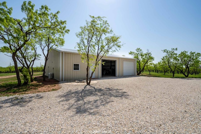 3734 Fm 600 S, Anson, TX 79501 - view of front of home featuring gravel driveway, an outbuilding, and a detached garage
