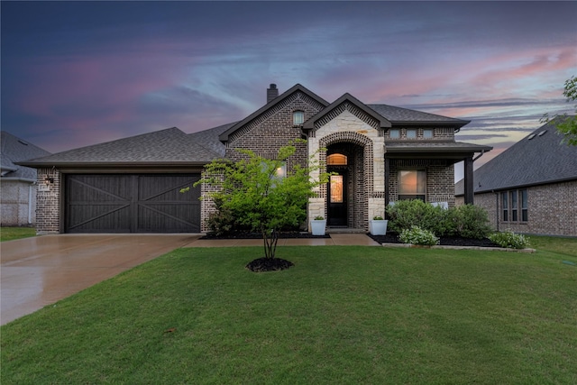 415 Valley Brook Ct, Waxahachie, TX 75165 - french country style house with concrete driveway, a chimney, a front yard, an attached garage, and brick siding
