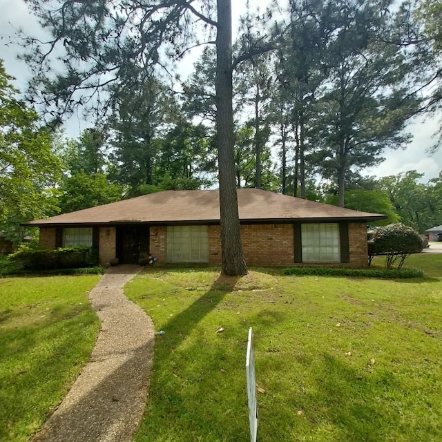 ranch-style house with brick siding and a front yard