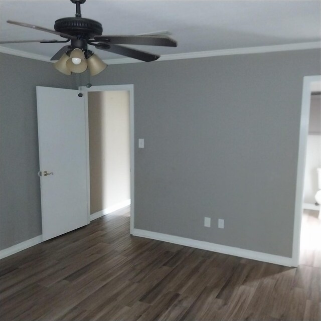 empty room with baseboards, ceiling fan, dark wood-style floors, and ornamental molding