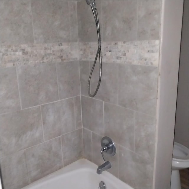 full bathroom featuring toilet and washtub / shower combination