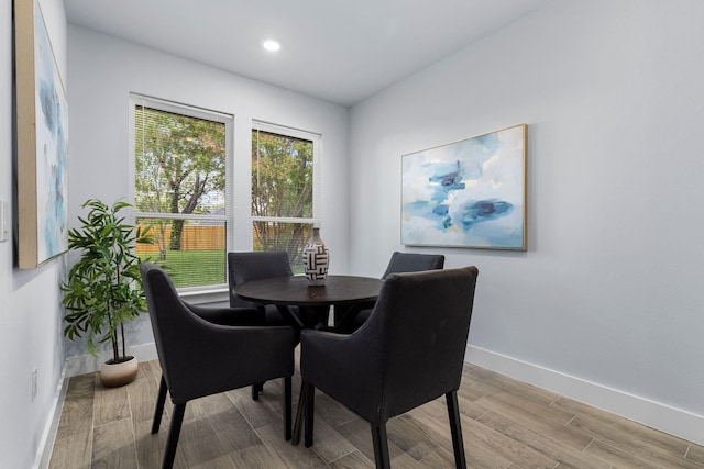 dining space with recessed lighting, wood finished floors, and baseboards