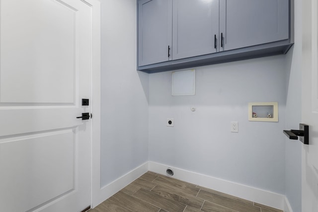 laundry area with hookup for an electric dryer, cabinet space, baseboards, wood finish floors, and washer hookup