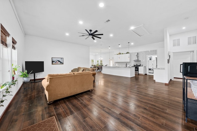 living room with recessed lighting, dark wood finished floors, and visible vents