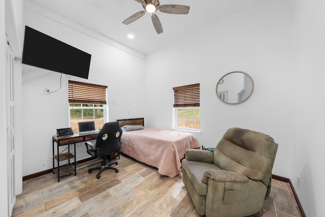 bedroom with recessed lighting, ceiling fan, light wood finished floors, and multiple windows