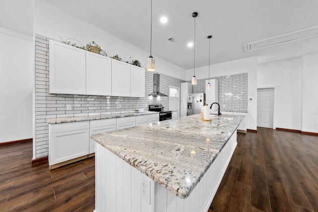 kitchen with stainless steel appliances, visible vents, wall chimney exhaust hood, white cabinetry, and dark wood-style floors