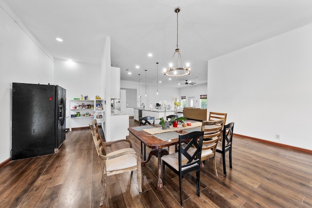 dining area with ceiling fan with notable chandelier, baseboards, recessed lighting, and dark wood finished floors