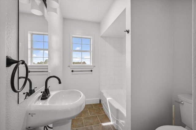 1631 E Farmers, Seagoville, TX 75159 - bathroom featuring tile patterned floors, bathing tub / shower combination, a sink, toilet, and baseboards
