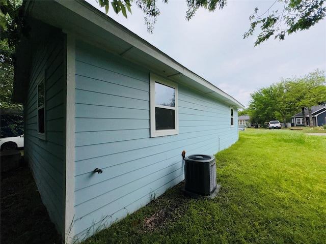view of home's exterior featuring central AC and a lawn