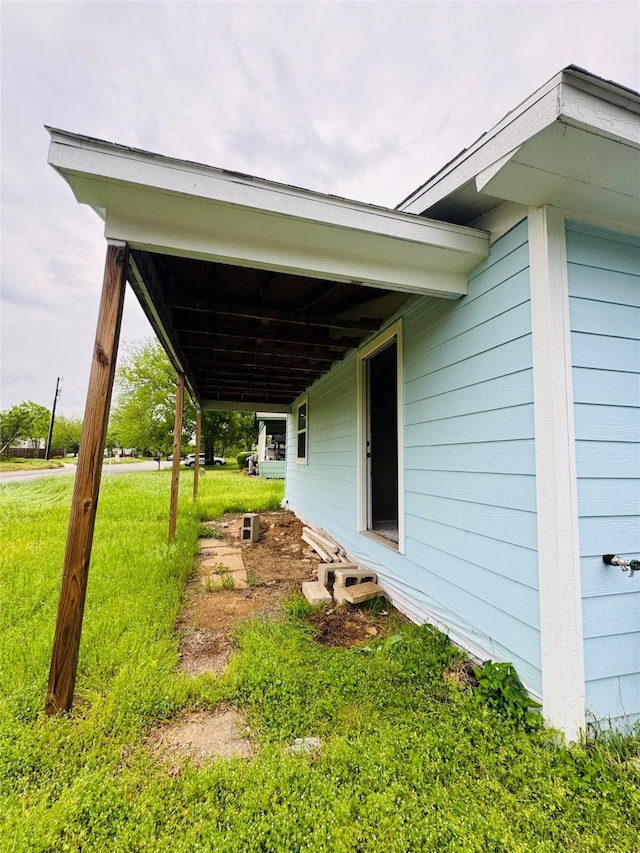 view of property exterior featuring a lawn