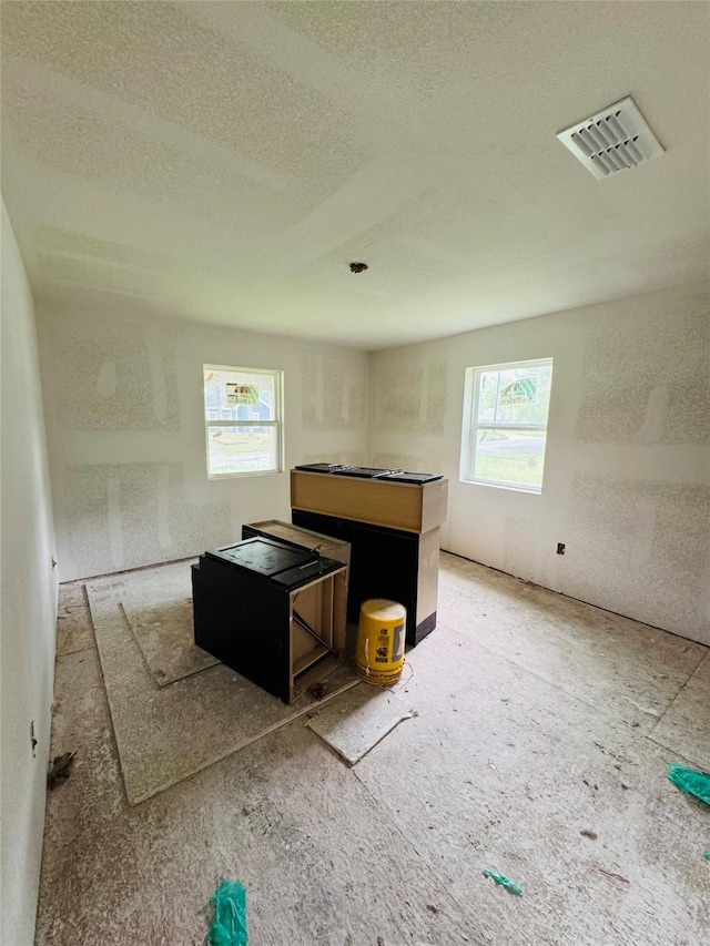 interior space featuring visible vents and a textured ceiling