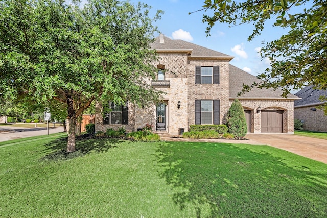 1001 Broadmoor Way, Roanoke, TX 76262 - view of front of home with a front lawn, brick siding, driveway, and a garage