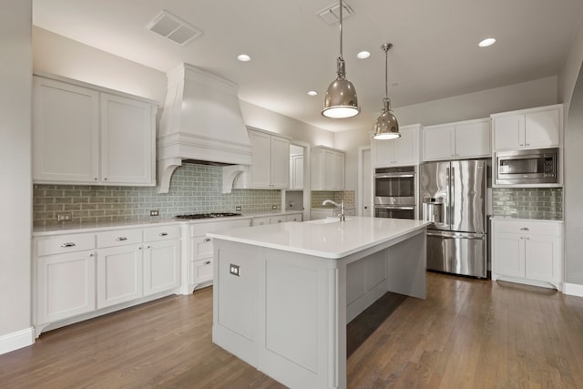 1001 Broadmoor Way, Roanoke, TX 76262 - kitchen with custom exhaust hood, appliances with stainless steel finishes, a sink, and visible vents