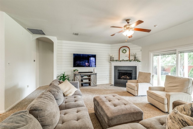 1109 Crest Meadow Dr, Fort Worth, TX 76052 - living room with wood walls, visible vents, a tile fireplace, light carpet, and a ceiling fan