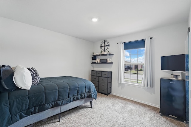 bedroom featuring carpet floors and baseboards