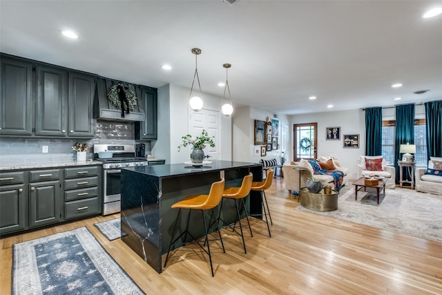 bar with custom exhaust hood, tasteful backsplash, light wood-style flooring, gas stove, and recessed lighting