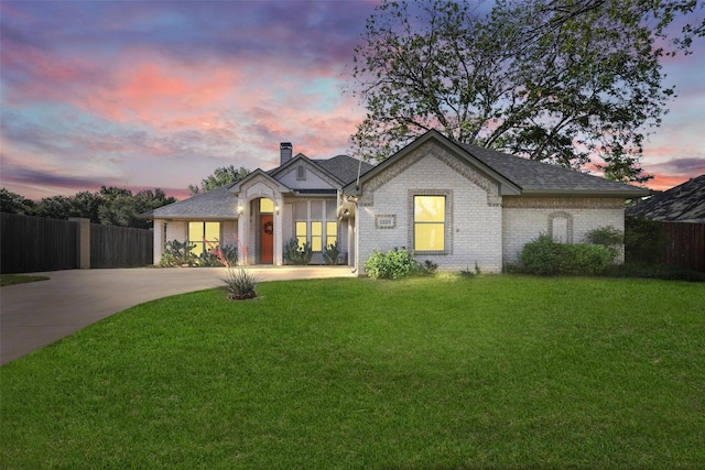 1220 Chaparral Ln, Granbury, TX 76048 - view of front of home featuring brick siding, a lawn, concrete driveway, and fence