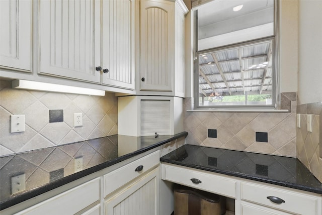 1220 Chaparral Ln, Granbury, TX 76048 - kitchen featuring white cabinets, tasteful backsplash, and dark stone counters