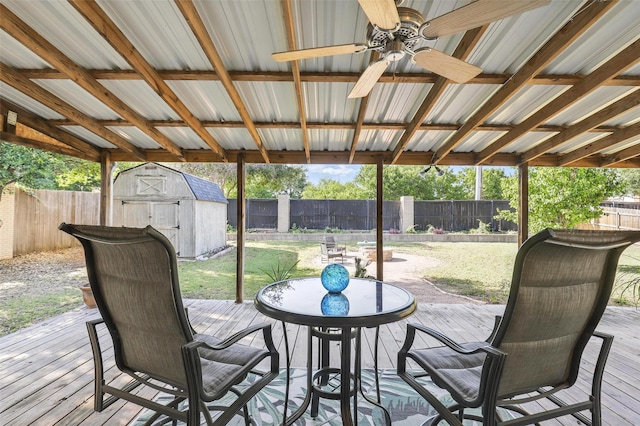1220 Chaparral Ln, Granbury, TX 76048 - wooden deck featuring a storage unit, a ceiling fan, outdoor dining area, and a fenced backyard