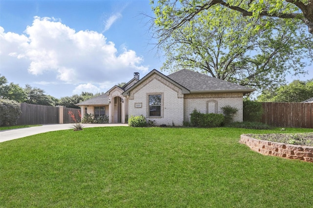 1220 Chaparral Ln, Granbury, TX 76048 - french country style house with a chimney, fence, a front lawn, driveway, and brick siding