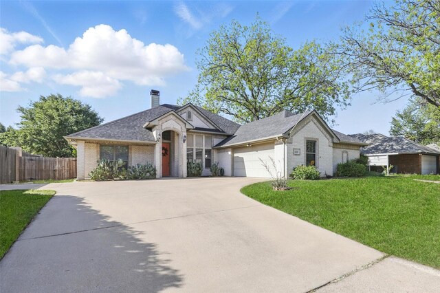 1220 Chaparral Ln, Granbury, TX 76048 - view of front of house featuring driveway, brick siding, a front yard, and a garage