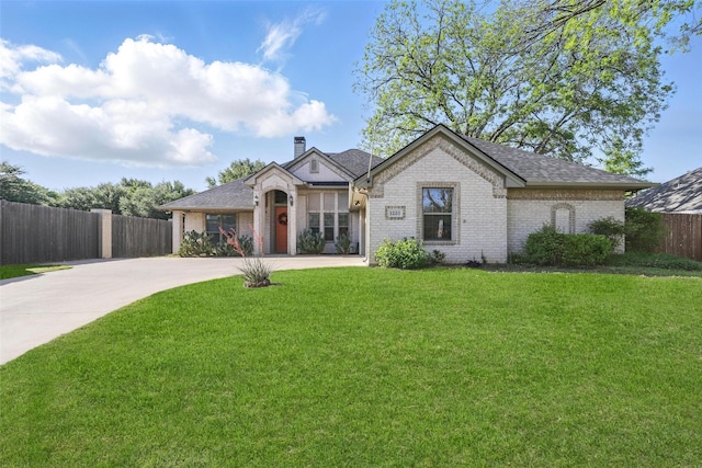 1220 Chaparral Ln, Granbury, TX 76048 - french country style house with a chimney, fence, concrete driveway, brick siding, and a front yard
