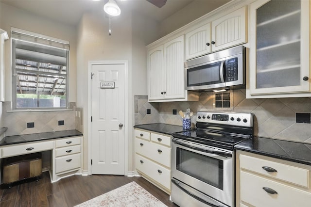 1220 Chaparral Ln, Granbury, TX 76048 - kitchen with glass insert cabinets, ceiling fan, stainless steel appliances, backsplash, and dark wood-style flooring