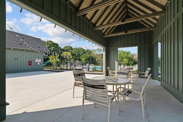 view of patio / terrace featuring a community pool and fence