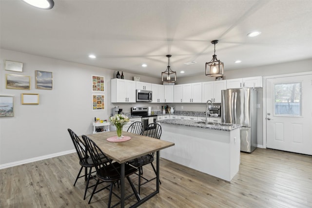 kitchen featuring light wood-style flooring, recessed lighting, and appliances with stainless steel finishes