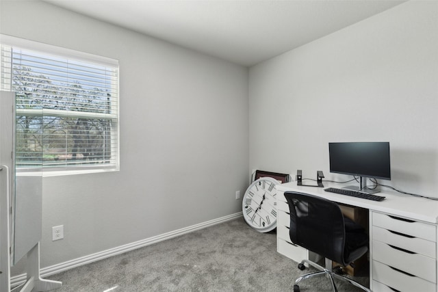 office with baseboards and light carpet