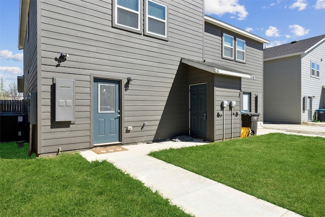 exterior space featuring a front yard and central AC unit