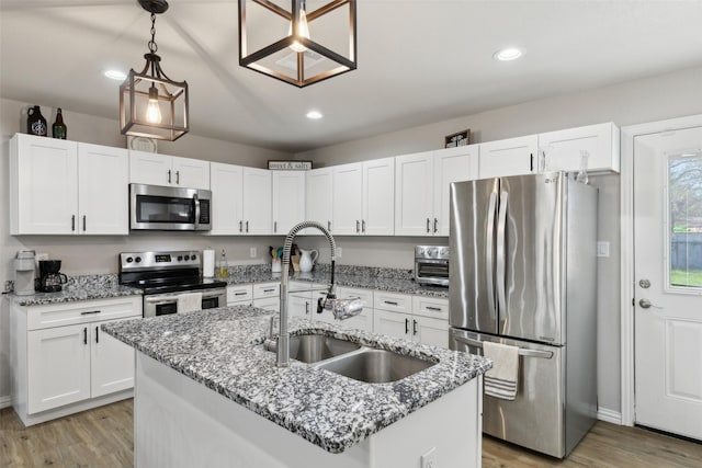 kitchen with white cabinets, stainless steel appliances, and a sink