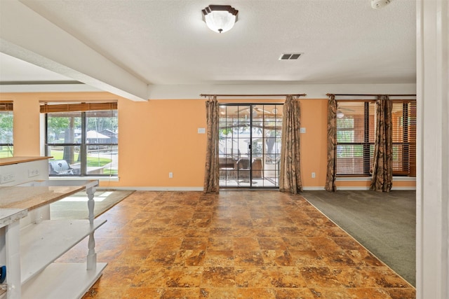 156 King Arthur Rd, Mabank, TX 75156 - unfurnished dining area with baseboards and a textured ceiling