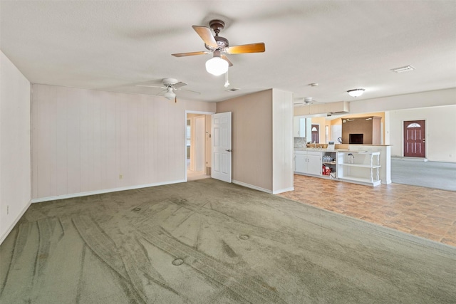 156 King Arthur Rd, Mabank, TX 75156 - unfurnished living room with baseboards, a ceiling fan, and carpet