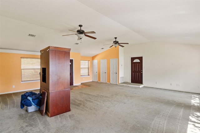 156 King Arthur Rd, Mabank, TX 75156 - unfurnished living room with carpet, a ceiling fan, baseboards, healthy amount of natural light, and vaulted ceiling